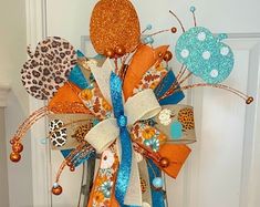 an orange, blue and white bow with leopard print decorations on it's front door