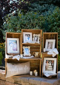 an outdoor display with pictures, candles and other items on the side of a brick wall