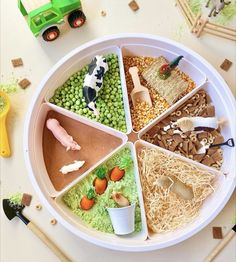 a white plate topped with different types of food and toy animals on top of it