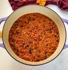 a pot filled with chili and beans on top of a table