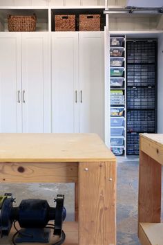 a workbench in a garage with lots of storage