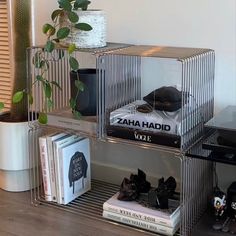 three tiered metal shelf with books and plants