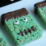 four green rice krispy treats with eyes and noses