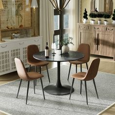 a dining table with four chairs around it