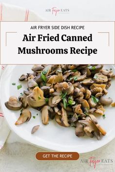 a white plate topped with mushrooms on top of a table