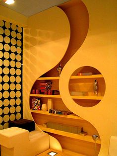 a living room filled with furniture next to a wall covered in circles on the walls