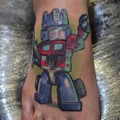 Baby Optimus prime  tattoo Optimus Prime Tattoo, Transformers Tattoo Ideas, Transformers Tattoo, Transformers Mtmte, Ideas For Tattoos, Optimus Prime, Tattoo Styles, Skull Tattoo, Cool Tattoos