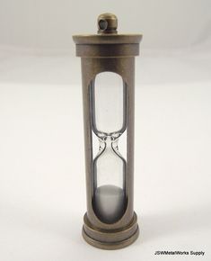 an old - fashioned hourglass is displayed on a white surface with space for text