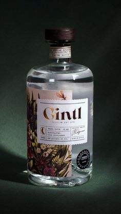 a bottle of ginu on a green background