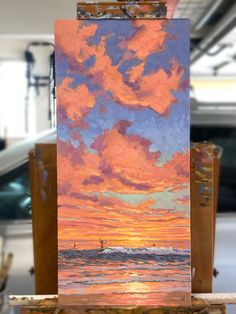 an easel with a painting on top of it