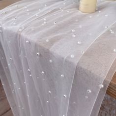 a white table cloth with pearls on it