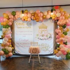 a decorated stage with balloons and decorations for a princess birthday party or baby's first birthday