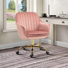 a pink office chair sitting on top of a wooden floor next to a desk and window