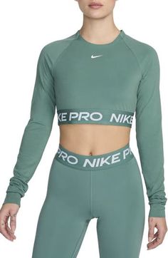 Nike Pro lettering details the stretchy, cropped hem of a second-skin top designed with sweat-wicking Dri-FIT tech that helps you stay dry and comfortable. 13 1/2" length (size Medium) Crewneck Long sleeves with thumbhole cuffs Dri-FIT moisture-wicking technology 83% polyester, 17% spandex Machine wash, dry flat Imported Nike Pro Shorts, Nike Pros, Second Skin, Dri Fit, Long Sleeve Crop Top, Women Long Sleeve, Nordstrom, Tops Designs, Crew Neck