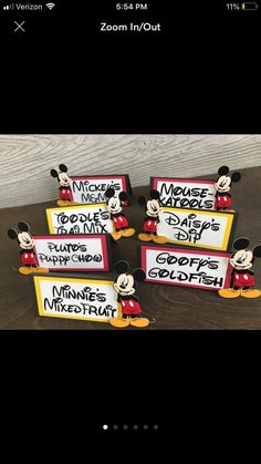 three mickey mouse signs with name tags on them