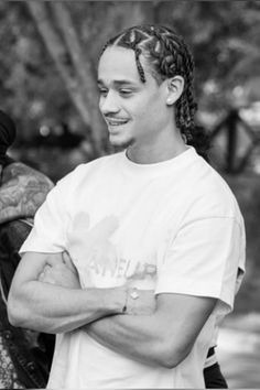 a man with dreadlocks standing next to another man