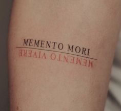 a woman's arm with the word mementoo mori written on it