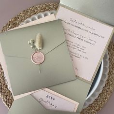 the wedding stationery is laid out on top of each other, with an envelope