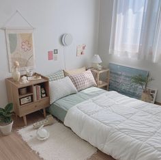 a small bedroom with a bed, nightstands and other items on the floor in front of a window