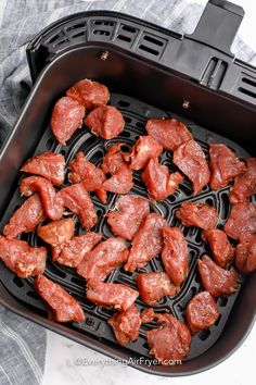 the meat is being cooked in an air fryer