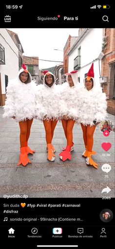 three women dressed in white feathers and orange shoes