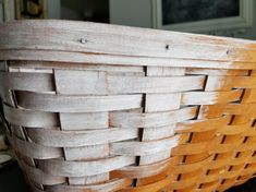 a wooden basket sitting on top of a table