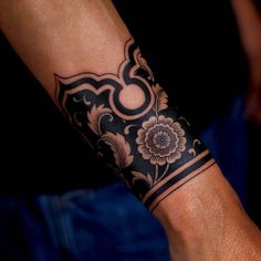 a man's arm with a tattoo on it and a flower in the middle