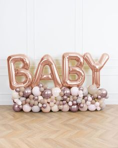 an image of baby balloon letters on the floor