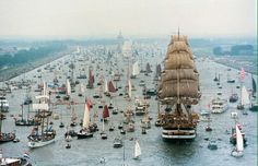 a large group of boats floating on top of a body of water next to each other