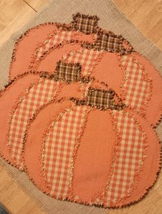 an orange pumpkin patchwork placemat on a wooden floor