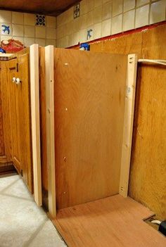 an unfinished kitchen with wooden cabinets in it