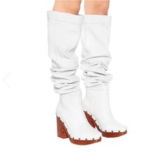 The Les Bottes Sabots Hautes Boots From Jacquemus’s Pre-Fall '19 Clog-Like Wooden Block Heels Optic White Naturally Creased Leather Panels Over-The-Knee Design Gold-Tone Studs Upper: Leather Lining: Leather Sole: Leather Insole, Rubber Sole Round Toe Made In Portugal Designer Colour Name: White True To Size European Sizes 11,5cm-4.5" Heel 3,5cm-1.5" Platform 69cm-27" Shaft Height 37cm-14.5" Shaft Width Shaft Width Measured On Largest Part Of Boot Nib Guaranteed Authentic Chic High Heel Boots With Wooden Heel, Spring Leather Platform Boots With Sculpted Heel, White Leather Square Toe Heeled Boots, Chic Closed Toe Boots With Rubber Heel Cap, Leather Platform Boots With Sculpted Heel For Spring, Chic Boots With Wooden Block Heel, Elegant White Leather Platform Boots, Designer White Boots For Spring, White Leather Boots With Padded Heel