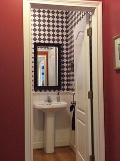 the bathroom is decorated in black and white checkerboard pattern, with a pedestal sink