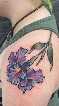 a woman with a flower tattoo on her shoulder