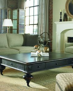 a living room with two couches and a coffee table in front of a fireplace