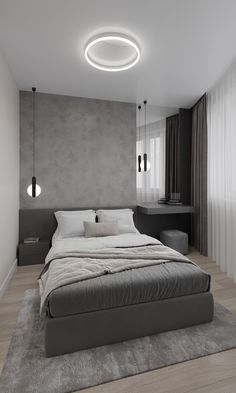 a large bed sitting in the middle of a bedroom next to a wall mounted light