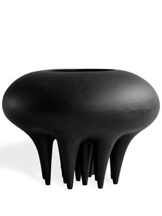 a black vase sitting on top of a table