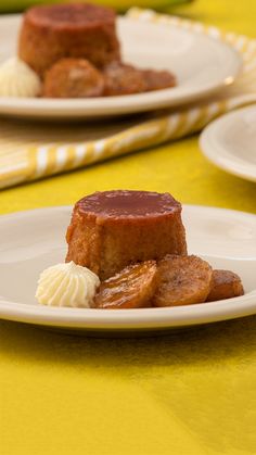 two white plates topped with desserts on top of a yellow tablecloth covered table