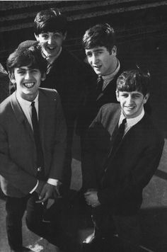 four young men standing next to each other