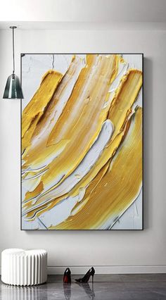 an abstract painting hangs on the wall next to a radiator and two lamps