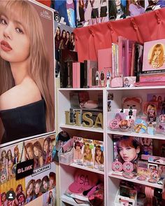 there is a display in the store with barbie dolls on it's shelfs