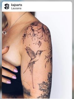 a woman's arm with a bird and flowers tattoo on the left side of her arm