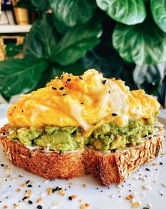 an open face sandwich topped with guacamole and sour cream on toasted bread