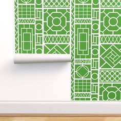 a green wallpaper with geometric designs on it