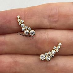 Bezel Set Unique Earrings, Cluster Winged Diamond Earrings, Round Cut Moissanite Anniversary Earrings Gift, 14k Gold Ear Climber Earrings  ✹✹𝐖𝐞𝐥𝐜𝐨𝐦𝐞 𝐭𝐨 𝑻𝒉𝒆𝑩𝒂𝒏𝒅𝒔𝑺𝒉𝒐𝒑✹✹ ★ 𝑺𝒕𝒐𝒏𝒆𝒔 𝑫𝒆𝒕𝒂𝒊𝒍𝒔 ★ ● Stone Shape:- Round Cut ● Stone Type:- Simulated Diamond, Moissanite, Lab-Diamond & Natural Diamond ● Stone Size:- 3.50 mm & 3 mm & 2.50 mm  ● Color:- DEF ● Clarity: VVS-VS ● Cut Grade: Excellent ● Making Process: Handmade - Crafted by our experienced team ★ 𝑰𝒕𝒆𝒎 𝑫𝒆𝒕𝒂𝒊𝒍𝒔:- ☛ Metal Purity: Solid Gold (10KT, 14KT, 18KT); Silver(925 Sterling, 935 Argentium), 950 Platinum ☛ Metal Tone: Yellow, White, Rose ☛ Stamp/Hallmark: Yes ★ 𝑪𝒖𝒔𝒕𝒐𝒎𝒊𝒛𝒂𝒕𝒊𝒐𝒏:- ☛ Customized Design Jewelry. ☛ All cuts which you dream to make with moissanite. ☛ Updating every step of you Anniversary Earrings, Cluster Earrings Studs, Gold Ear Climbers, Ear Climber Earrings, Diamond Cluster Earrings, Ear Climbers Earrings, Ear Climber, Yellow Gold Earrings, Climber Earrings