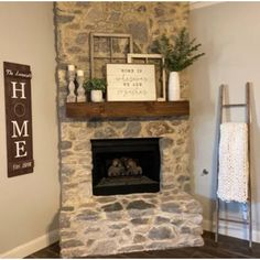 a stone fireplace in a living room next to a towel rack