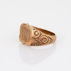 This is part of Chairish’s Fine Jewelry assortment.  Lovely antique Victorian shield signet ring (circa 1880s to 1900s), crafted in 14 karat rose gold.   From what we can decipher, the centre shield is engraved with the initials "SL".   The side shoulders feature a pretty scrolling design that terminates to the shield mount. The saddle of the ring is low and curves to the shape of the finger.     The ring is in good condition with patina and wear evident. We have not cleaned the ring in order to Late 20th Century, Antique Victorian, Signet Ring, Saddle, 20th Century, Patina, Initials, Fine Jewelry, Rose Gold