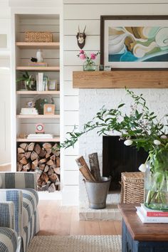 a living room filled with furniture and a fire place next to a wall mounted book shelf