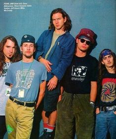 a group of young men standing next to each other in front of a blue wall