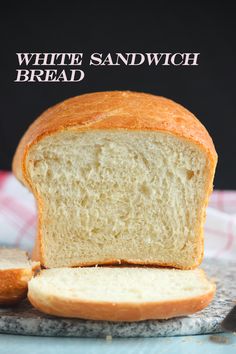 a loaf of white sandwhich bread sitting on top of a cutting board